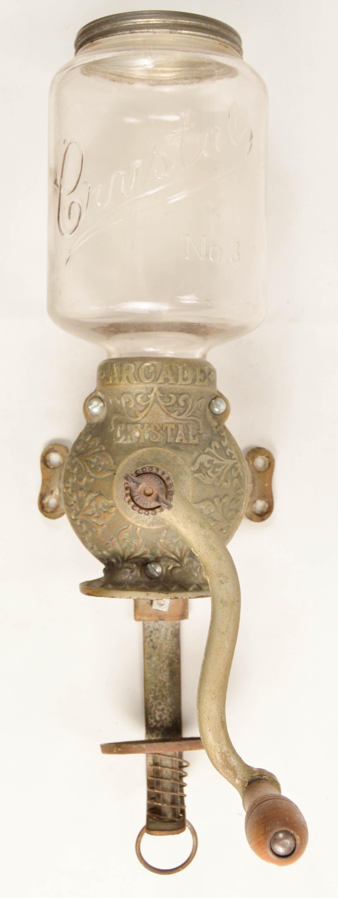Arcade No. 3 Wall Coffee Grinder: Wall mount hand crank coffee grinder made by the Arcade Mfg. Co. of Freeport Illinois. This is an Arcade Crystal No. 3 With embossed hopper glass and embossed hopper lid. In good original condition. T