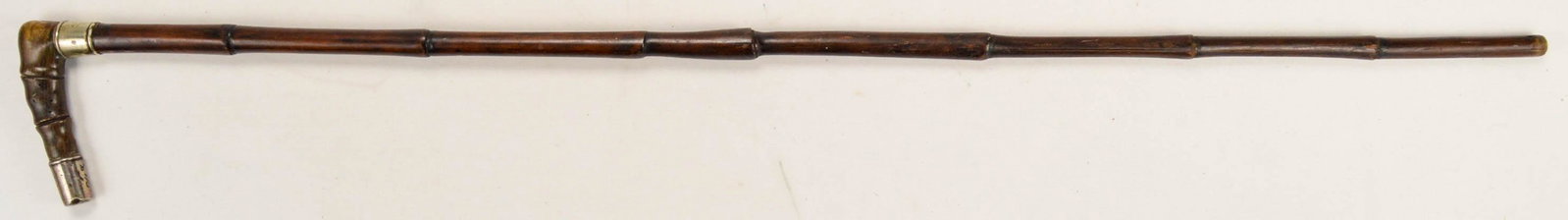 Vintage Wood Walking Cane with Silver Trim: Vintage wood (bamboo style looking wood) with silver band and cap, with a bone type material for handle. Good condition 35" long