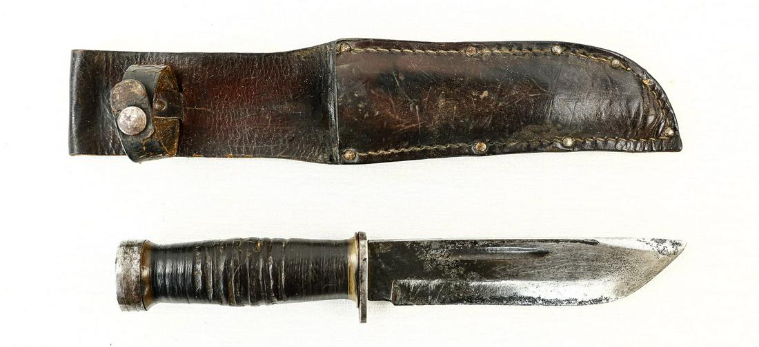 US Fighting Knife: Blade has been heavily oxidized on one side and retains a pointy tip. Blade has some nicks and dings. Ricasso is marked "Cattaraugus, 225Q" on one side. Blade measures 6" in length. Knife has a simple
