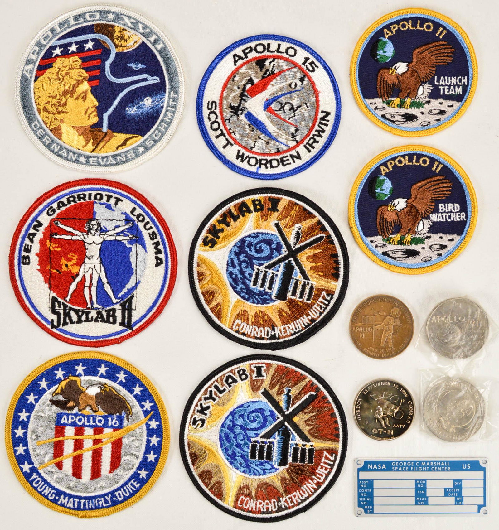 Lot of NASA Patches and Coins: Lot of NASA Patches and Coins. Includes 8 badges and 4 coins, plus an unused metal equipment tag plate from the George C. Marshall Space Flight Center. See photos.
