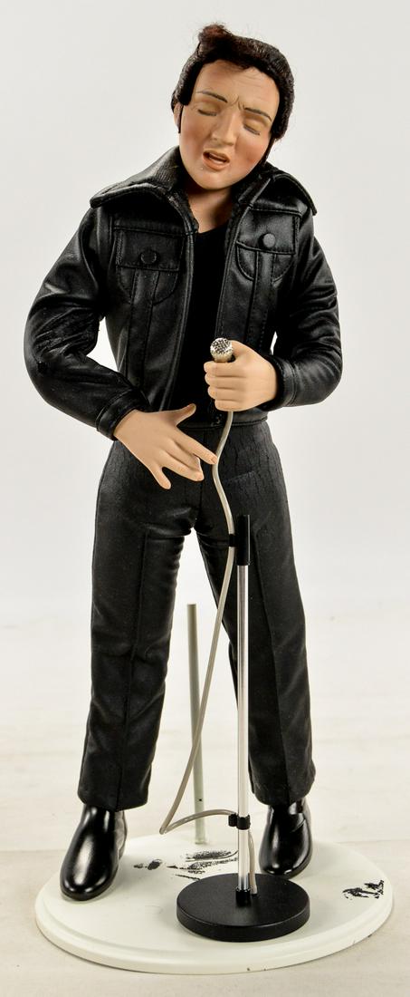 Elvis Presley Ashton-Drake Porcelain Doll: A standing porcelain doll of Elvis Presley singing into a microphone by the Ashton-Drake Galleries. The doll comes in box though the box lid is missing. Doll is in good condition. See photos.