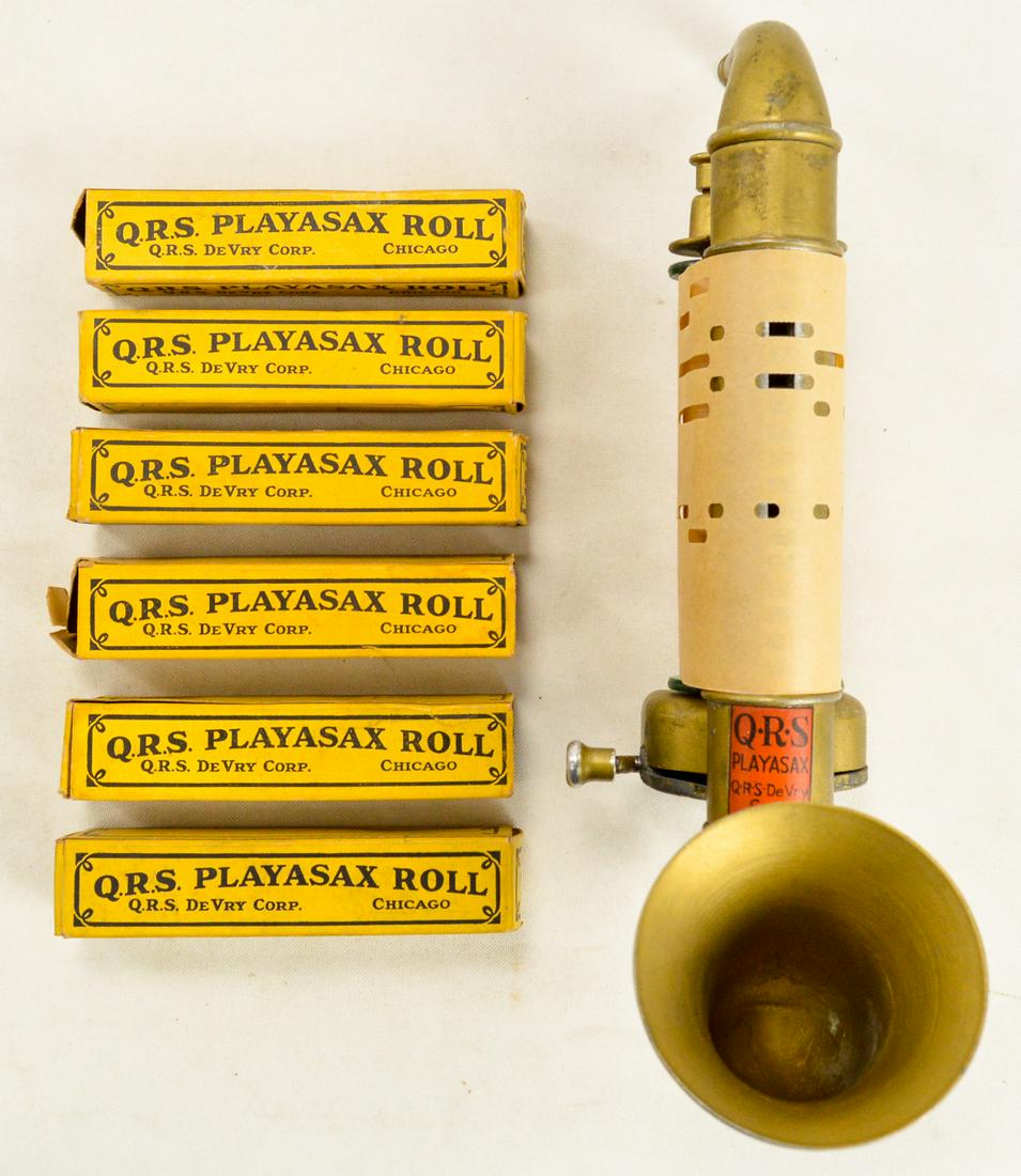 Play-a-Sax w/ 7 Rolls: QRS Play-a-Sax from 1930 with 7 rolls, 6 are in their original boxes. To play, blow into the top and turn the handle. Still works. Has some wear from age and use but still in good condition. See photo