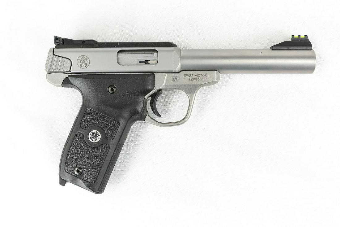 Smith & Wesson SW22 Victory Pistol .22LR: 5.5" barrel, double stainless finish. Adjustable sights. Excellent used condition with factory box and accessories. Has some nicks and scratches. SN: UDW8054 ALL GUNS MUST GO TO C&R OR FFL