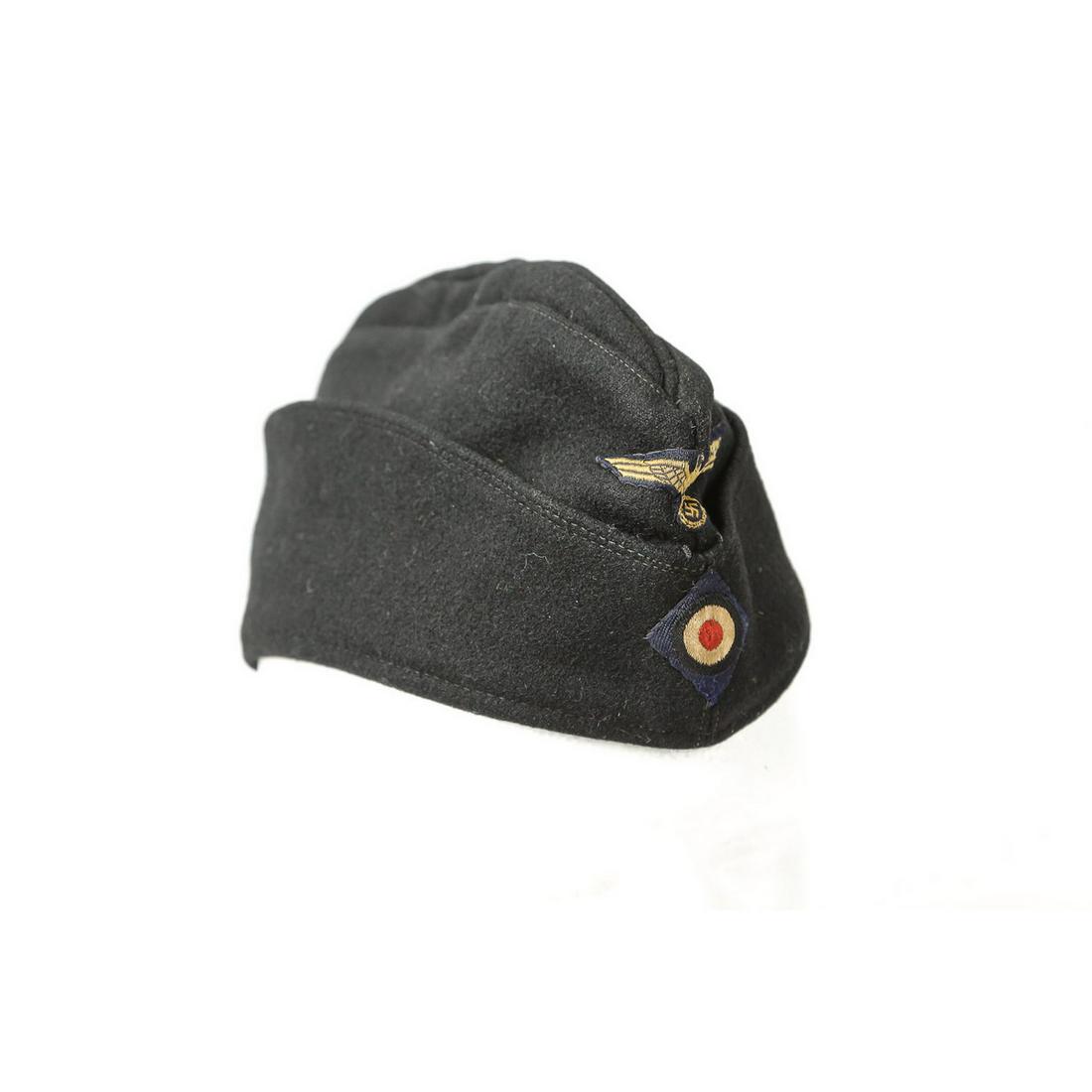 WWII German Kreigsmarine EM Side Cap: A German EM side cap featuring the Kreigsmarine eagle above the blue-white-red cockade at the front with the cap being made of dark, navy blue wool. White lettering on inside of cap is partially faded