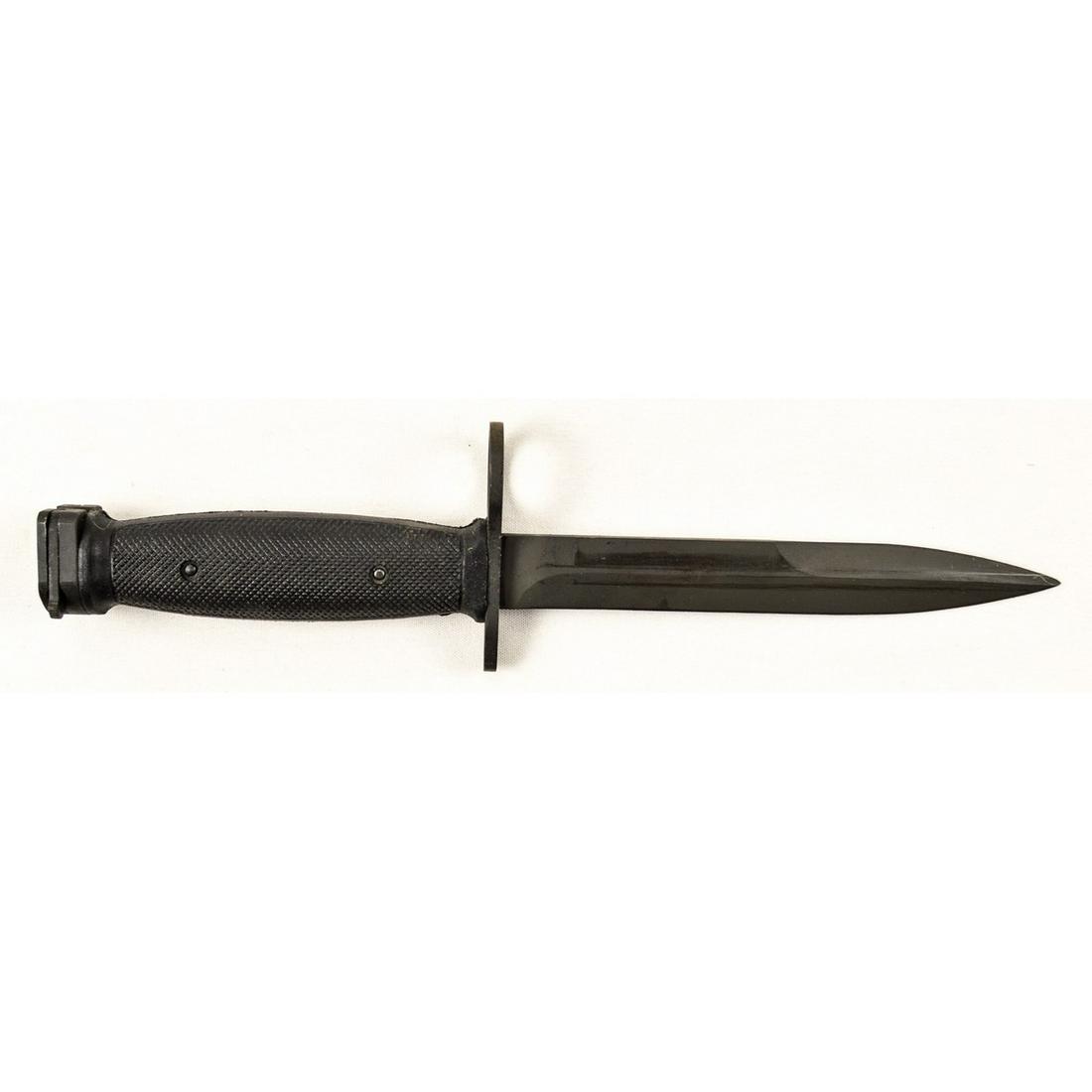 S1 Pindad Indonesian Bayonet: Patterned after the US M7 bayonet and used by Indonesia. Bayonet has black parkerized finish in excellent condition with finish wear from scabbard. Black plastic grips are in very good condition. Come