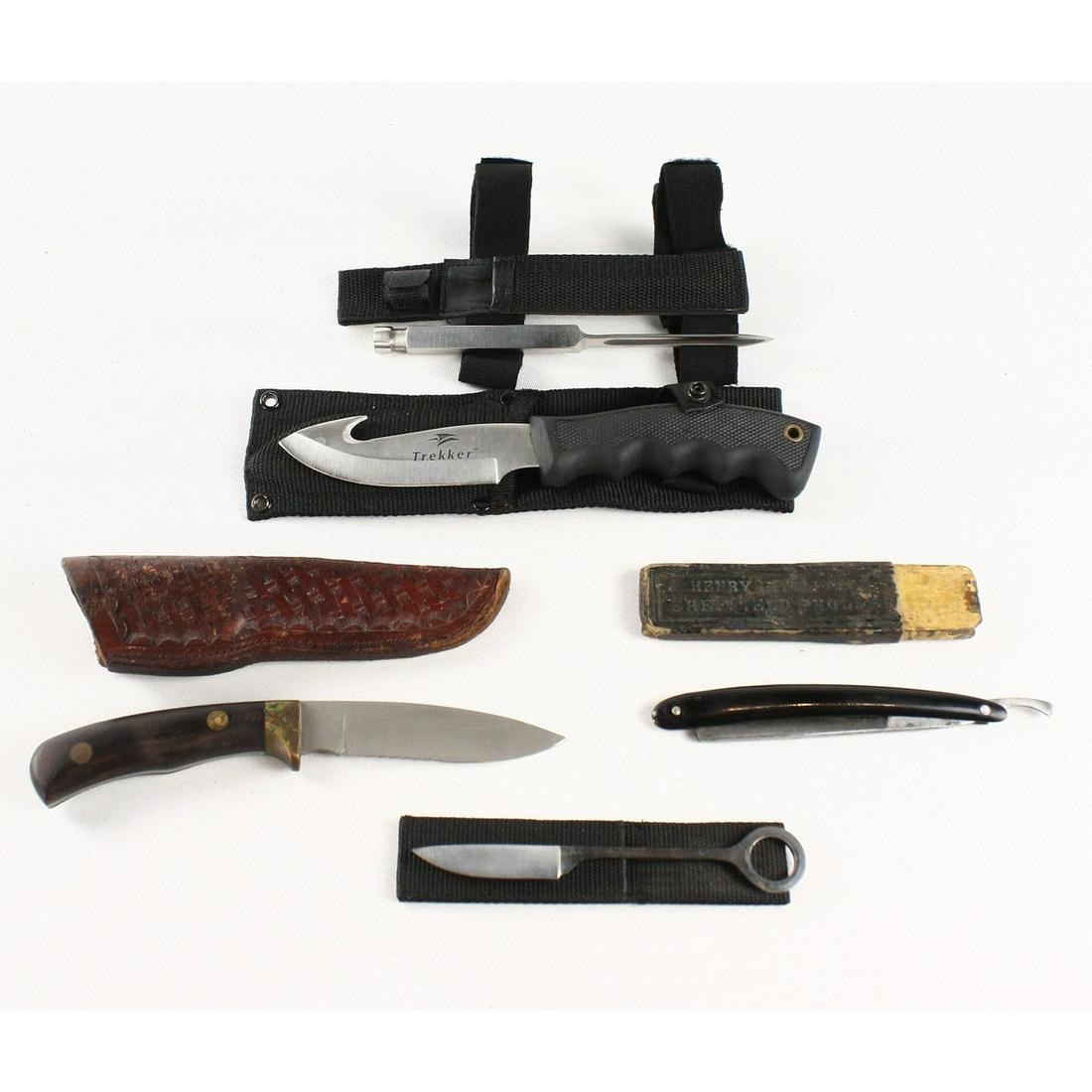 Lot of 4 Knives and a Straight Razor: This lot contains 5 various knives. They are all in used condition. There is a Trekker, Fury, and a Schultz in this lot as well as a straight razor in a box labeled 'Henry Littlewood Sheffield England