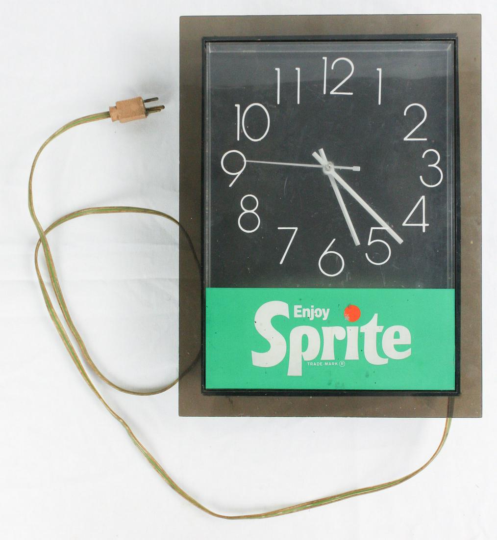 Sprite Advertising Clock: This is an Advertising clock for Sprite soda. Likely from the 60's or 70's. It lights up and clock works when plugged in. A neat piece of soda advertising. Measures 16"x12" The clock is in good used c