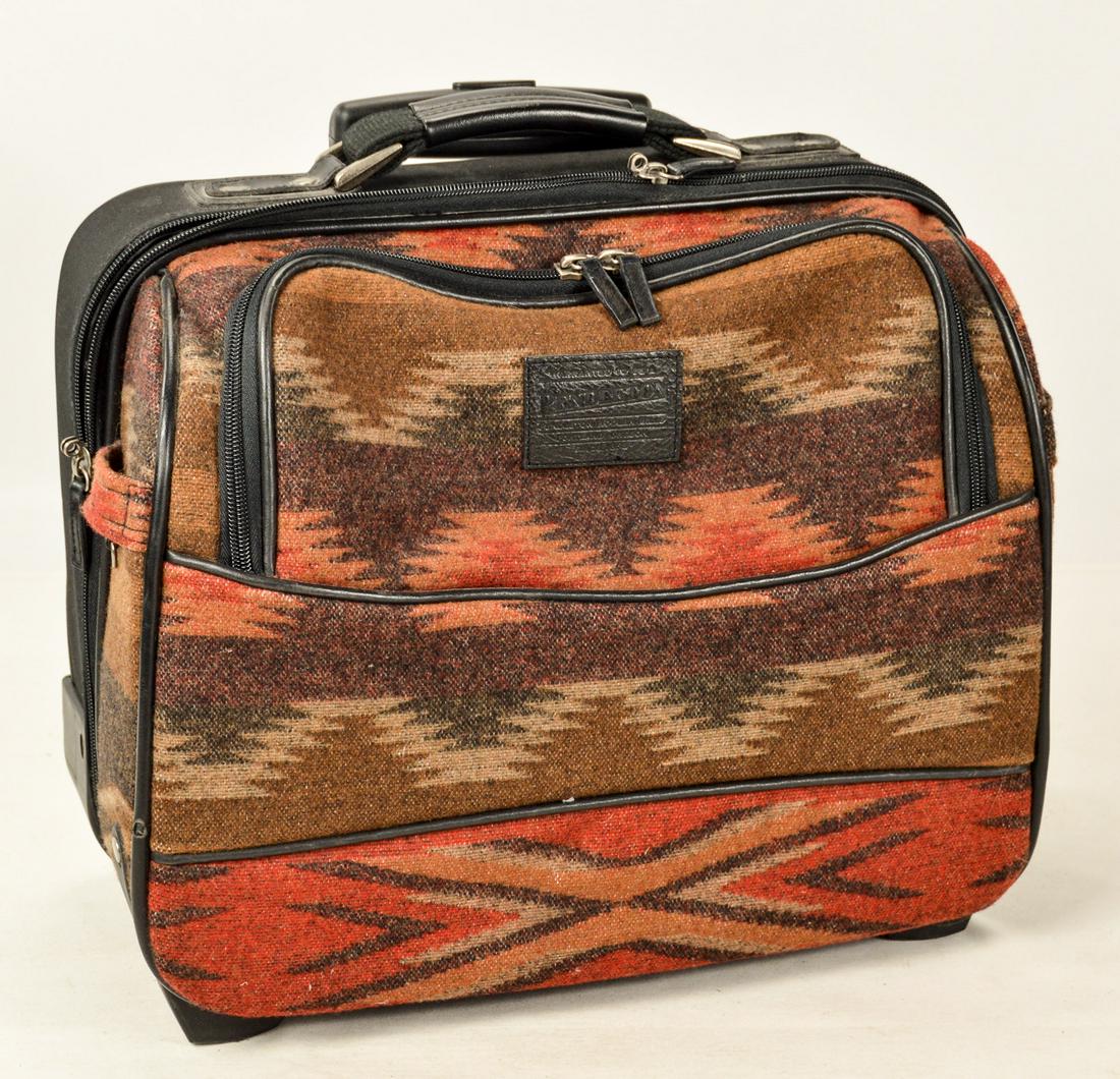 Pendleton Rolling Suitcase: A rolling suitcase by Pendleton Woolen Mills of Portland, OR. Suitcase has patterned wool exterior with telescoping handle. Excellent condition. Measures 16"W x 14"T x 8.75"D. See photos.