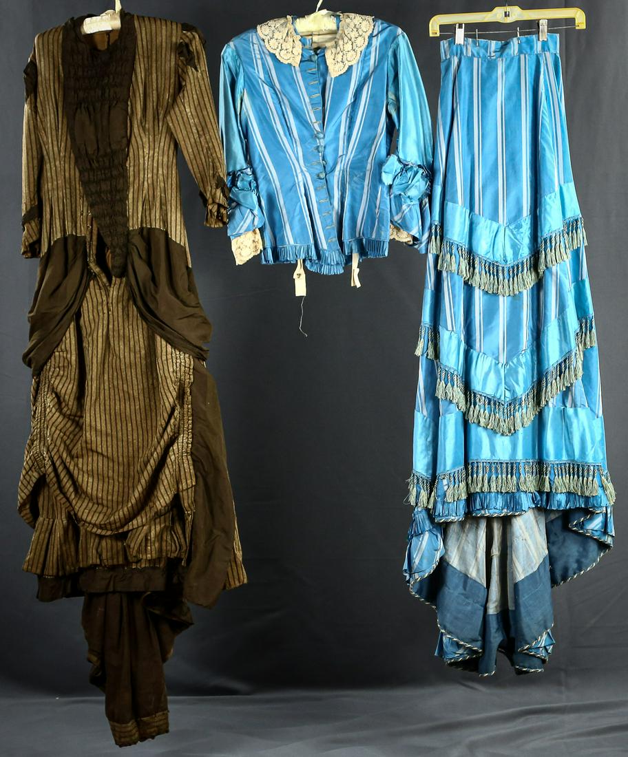 Two 1870's Women's Outfits: 1. Chocolate brown striped full skirt dress worn with a bustle. Satin collar inset. Satin insets on sleeves and skirt. Slight hanger damage. Snaps up the front. 32" bust, 26" waist. Small train. Very 