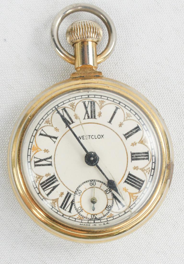 Westclocks Gold Filled Pocket Watch: Westcloks pocket watch. Winds and runs. Cracked plastic crystal. In working condition. Engraving of train on back of watch. See photos.