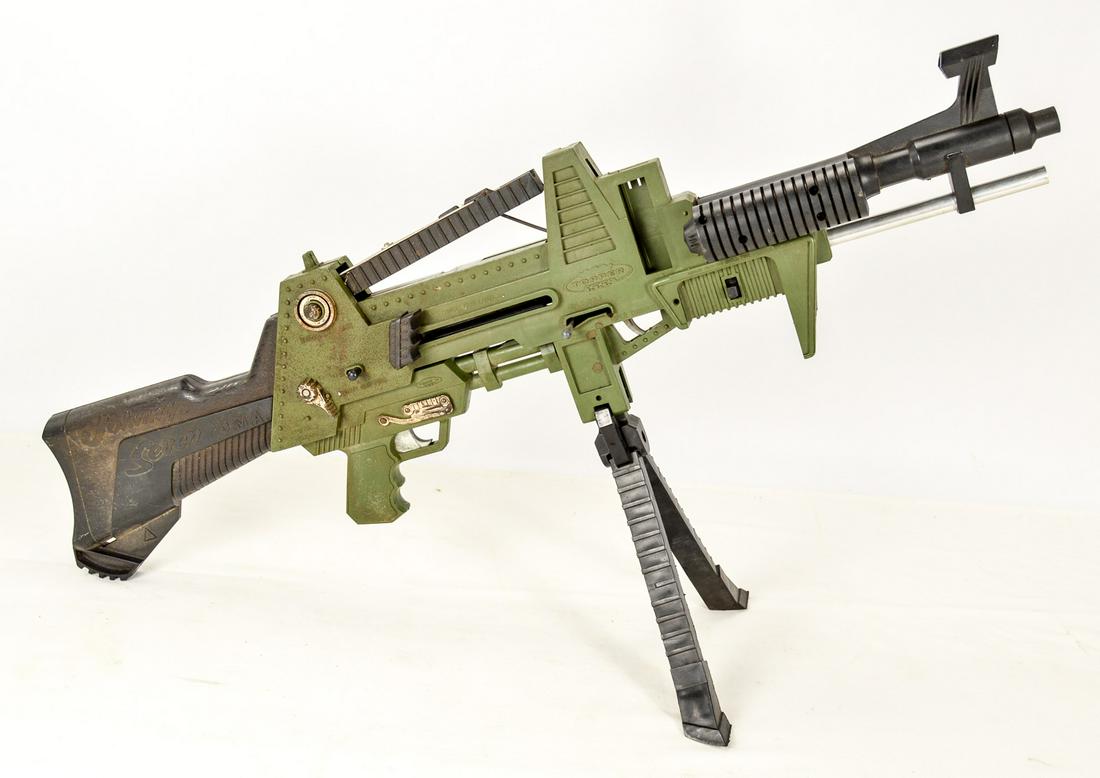 Johnny Seven Vintage Toy Machine Gun: This is a multi-gun toy. It sets up as a machine gun, can be carried as a rifle, and has a pistol that releases from the underside. It is in used condition. See photos.