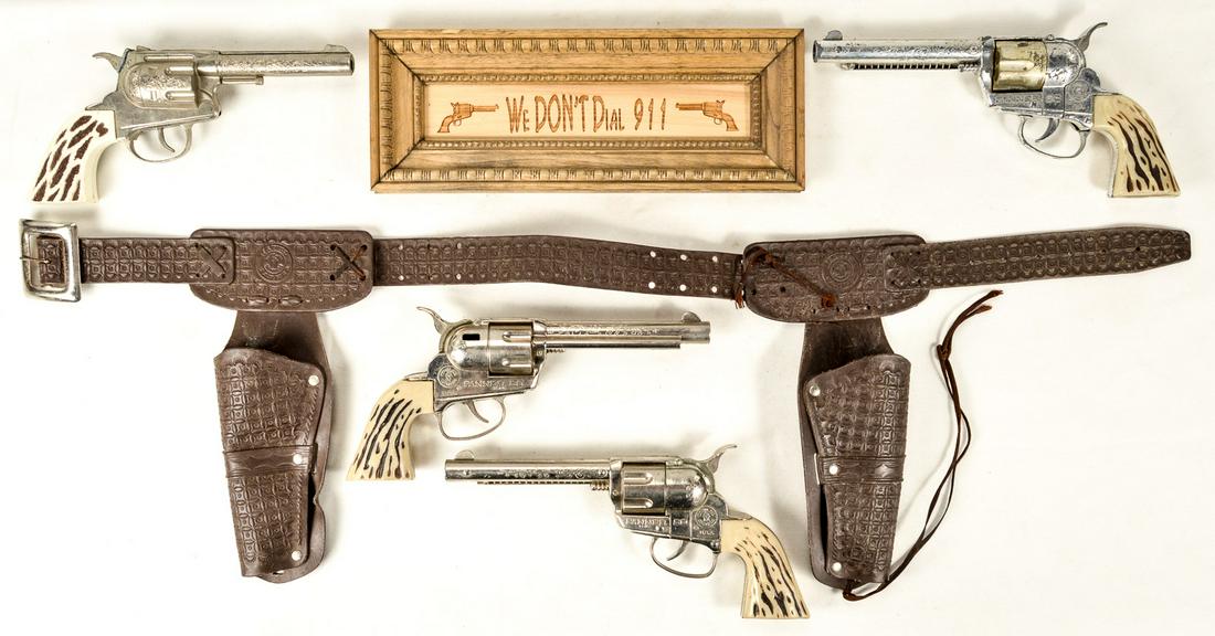 Cowboy Toy Revolvers, Holsters and Sign: This lot comes with 4 toy guys, a double gun belt holster, and a small sign that says "We Don't Dial 911." See photos
