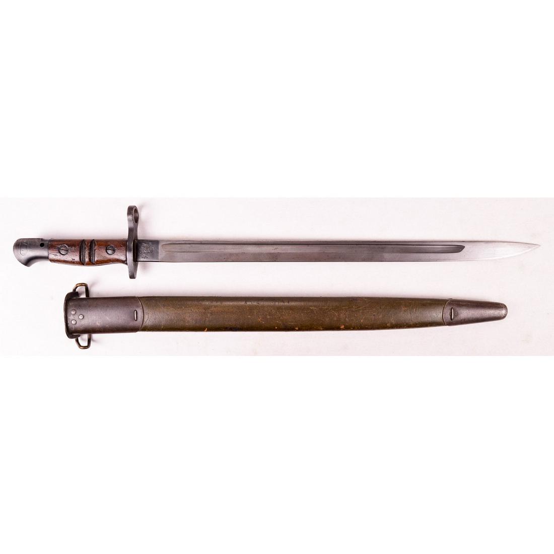 US M1917 Bayonet & Scabbard: A US M1917 bayonet and scabbard for use with the M1917 rifle. Bayonet ricasso is marked "1917" and "Remington" on one side with "U.S." and markings on other side. Blade has some minor oxidation with a