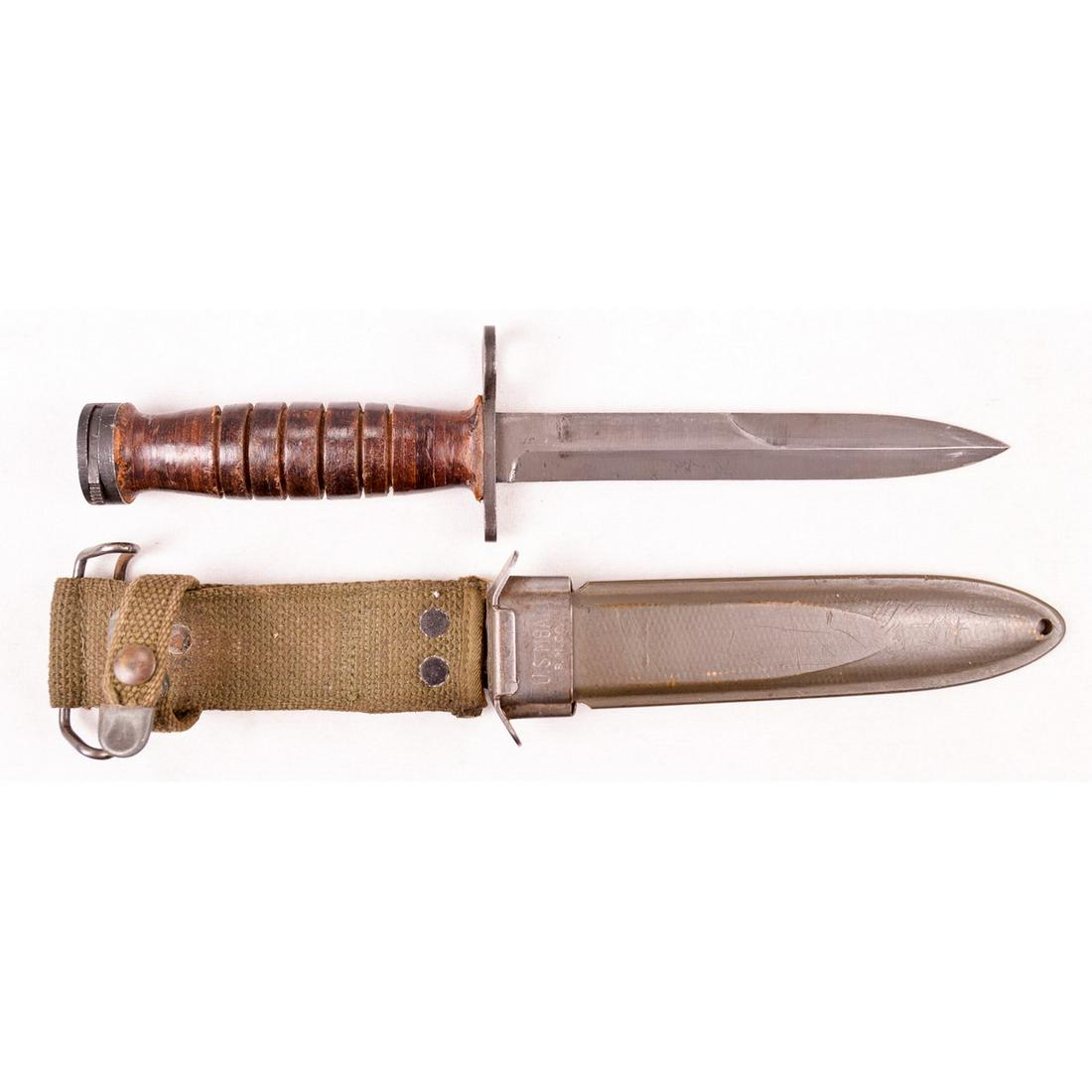 US M4 Utica Bayonet and M8A1 Scabbard: US M4 Utica made bayonet with M8A1 scabbard. Hand guard is marked "US M4 Utica", blade is in great condition with edge and point, wood grips have some wear from age and locking lugs work. Used for the