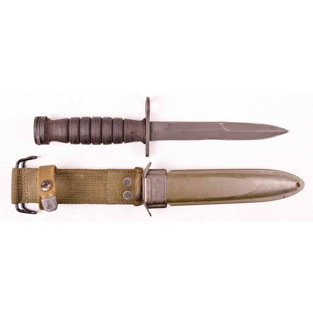 US M4 Camillus Bayonet and M8A1 Scabbard: US M4 Camillus made bayonet with M8A1 scabbard. Hand guard is marked "US M4 Camillus". Blade is in great condition with edge and point, wood grips have some wear from age and locking lugs work. Used f