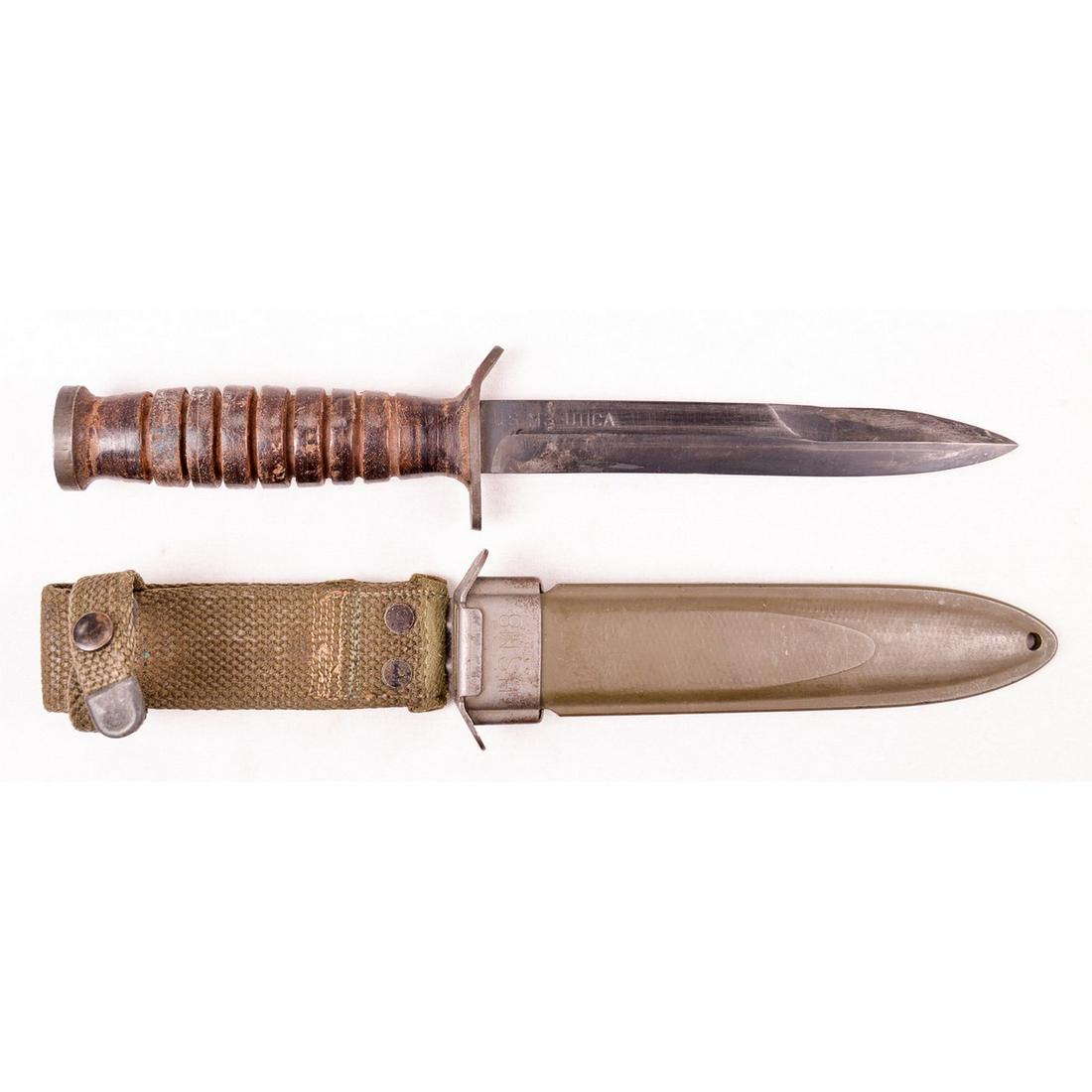 WWII US M3 Trench Knife: US M3 trench knife. Edge and point of the blade are very sharp and blade length is 6.5" long. Blade is marked "US M3-Utica" and has some wear from use. Scabbard comes with canvas frog and retains 95%+