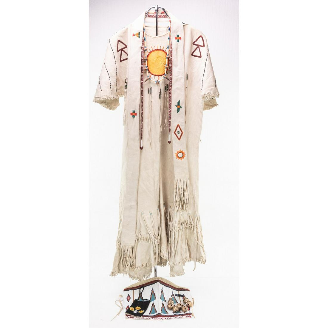 Native American Style One Piece Dress: A Native American style one piece dress with embroidered bead sun on front and back. Dress features striped beading on short sleeves and double stacked upwards triangles on shoulder front and backs. T