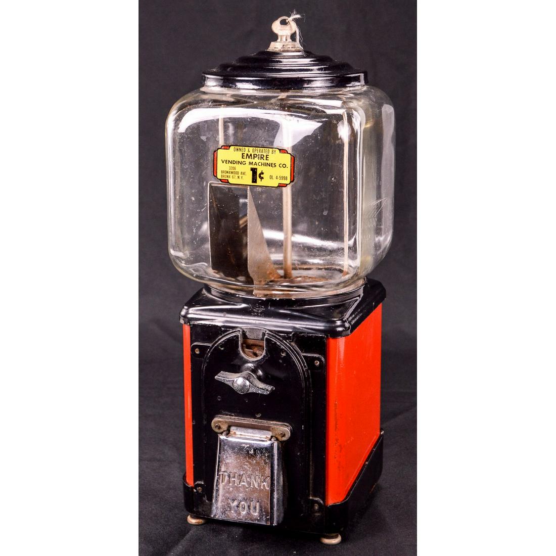 Empire 1¢ Gumball Machine: A 1 cent gumball machine made by Empire Vending Machines Company. Paint on the machine is 90%+ present with some minor paint loss around the edges. Comes in a nice red and black color scheme. Machine