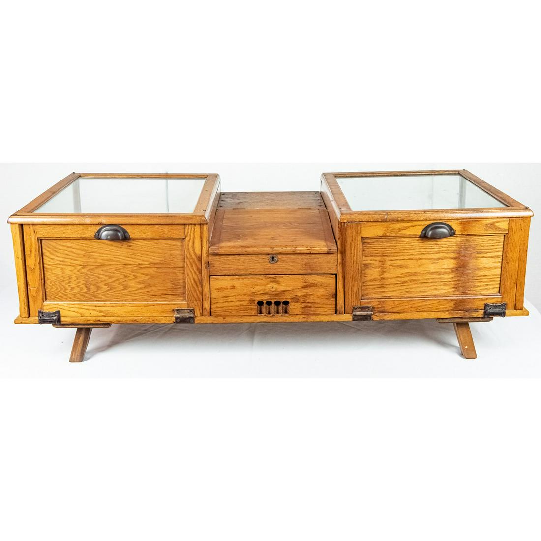 Countertop Oak Double Showcase: Nice early countertop store showcase features side by side showcases with a center counter cash drawer. Oak framed showcases measure 19" wide, 22" deep, 11" tall each with spring loaded rear door entr