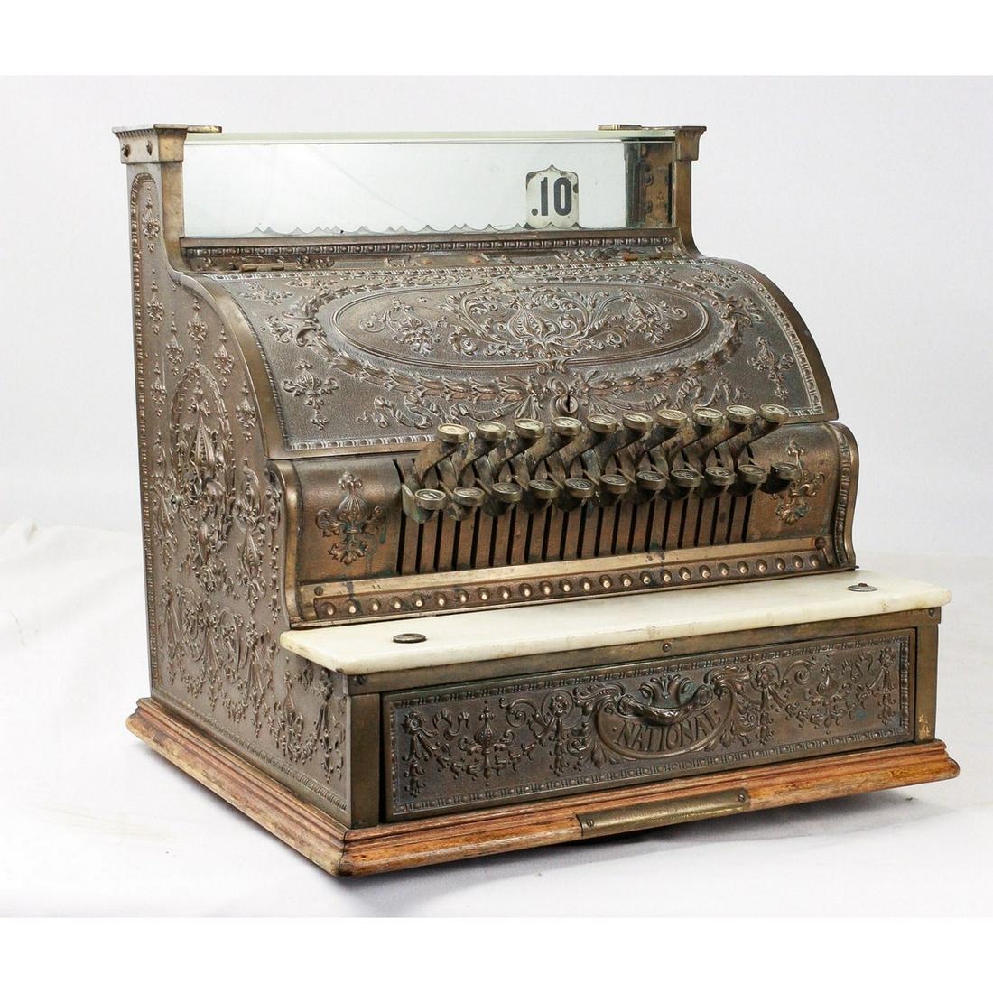 National Cash Register: All brass cash register without front key. Model number has been worn away but the tag is still present, appears to be a model 333. No marquis and has some chips on the edges of the glasses. Under the