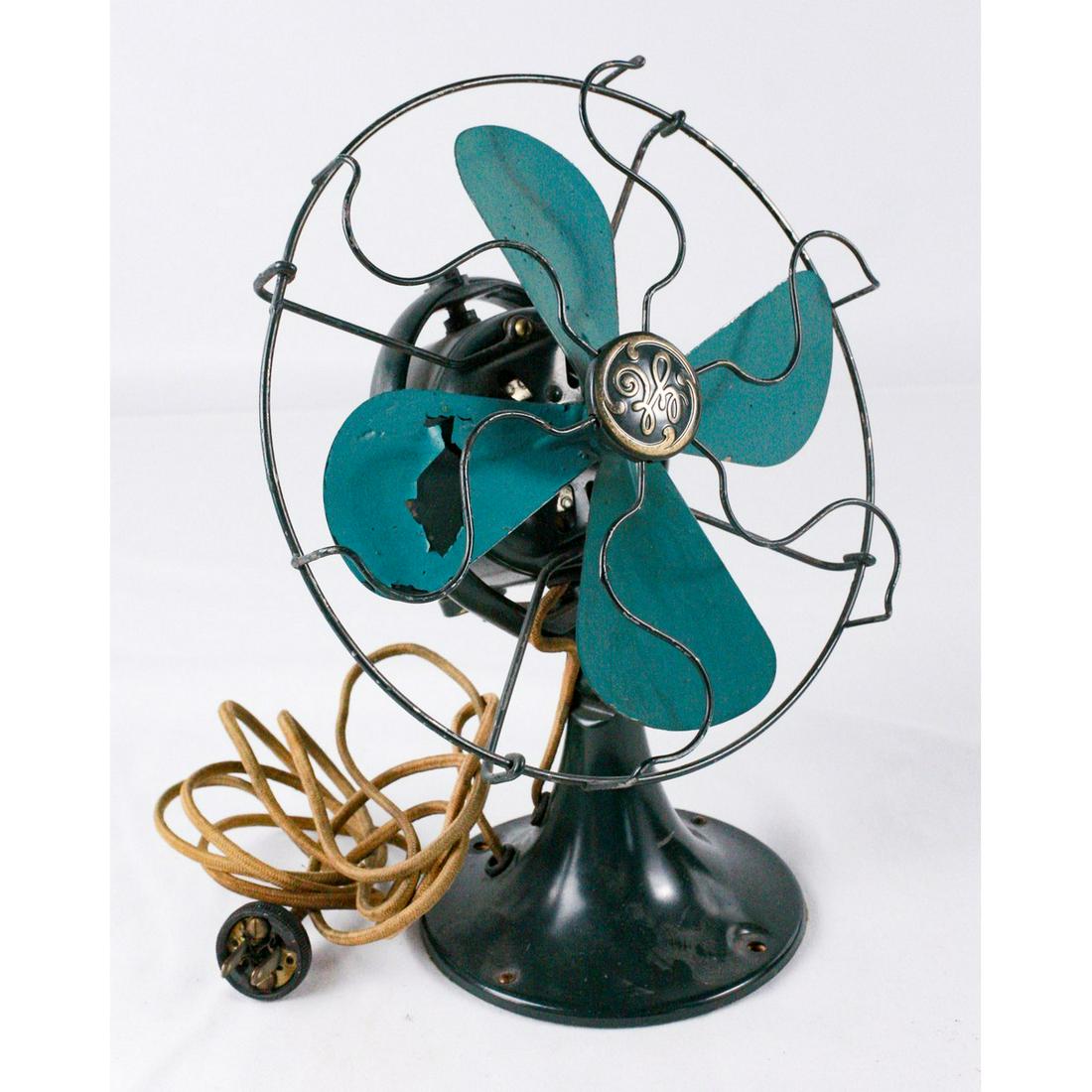 General Electric 8 Inch Oscillating Fan: General Electric 8 inch oscillating fan, made in 1931. Nice green fan with a label on the bottom of the base reads "CAT 42x528 CON. SPEC. 272357-1" with instructions on how to use the fan. One fan bla