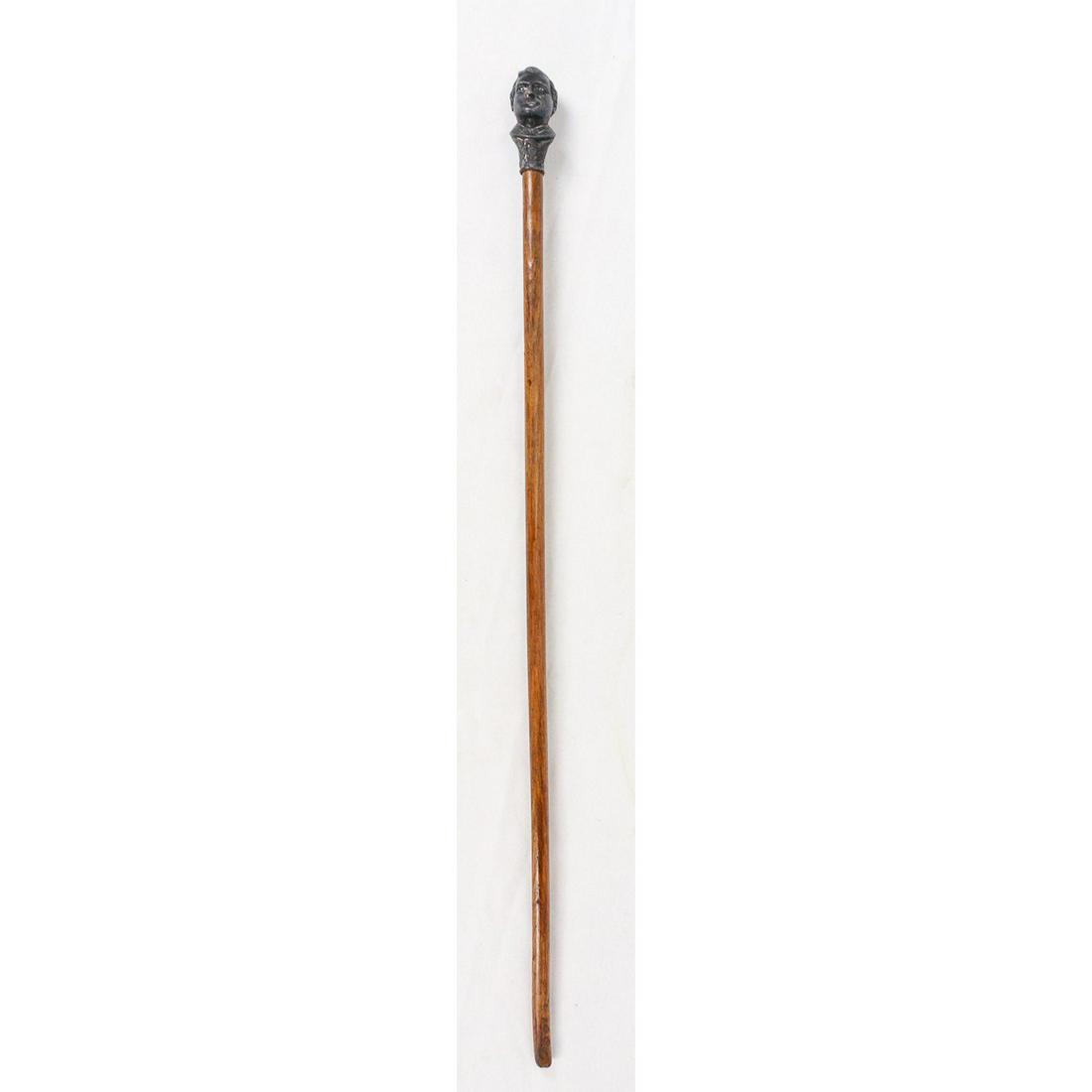 Presidential Candidate Walking Stick Wall Decor: Presidential candidate walking stick that has a bracket for mounting on a wall. This is for the 1896 election and depicts candidate William Jennings Bryan. This cane is related to the William McKinley