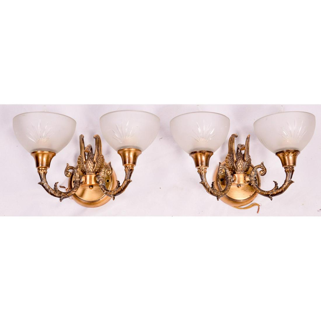 Pair of Vintage Figural Brass Sconces: This handsome pair of wall sconces are made from solid brass with the original crystal wheel cut shades. Classic design features with its decorative arms a swan. Original antique brass finish with som