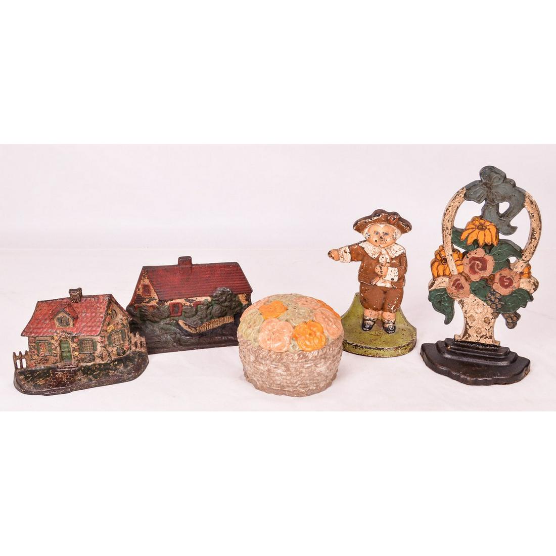 Lot of 5 Vintage Doorstops: Circa early 20th Century. Includes: Cast iron of A small pilgrim boy. No maker markings present. Cast iron of a red-roofed cottage with picket fence - no makers mark present. Cast iron red-roofed hous