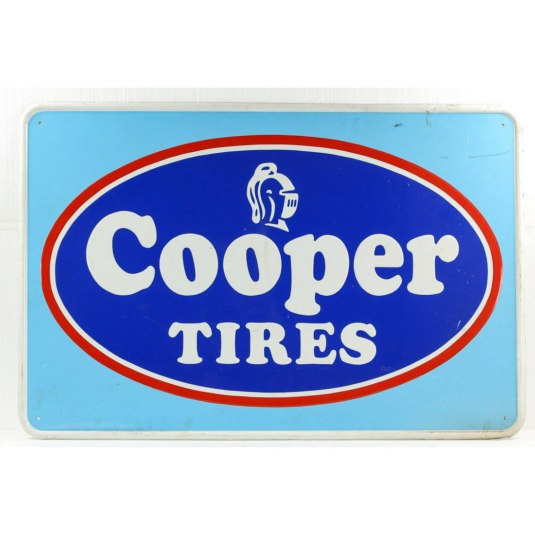 Cooper Tires Single Sided Advertising Sign: A single sided tin sign advertising Cooper Tires. Sign depicts Cooper Tires logo and name in white and both are embossed. Sign has white beveled border and light blue background. Front of sign has som