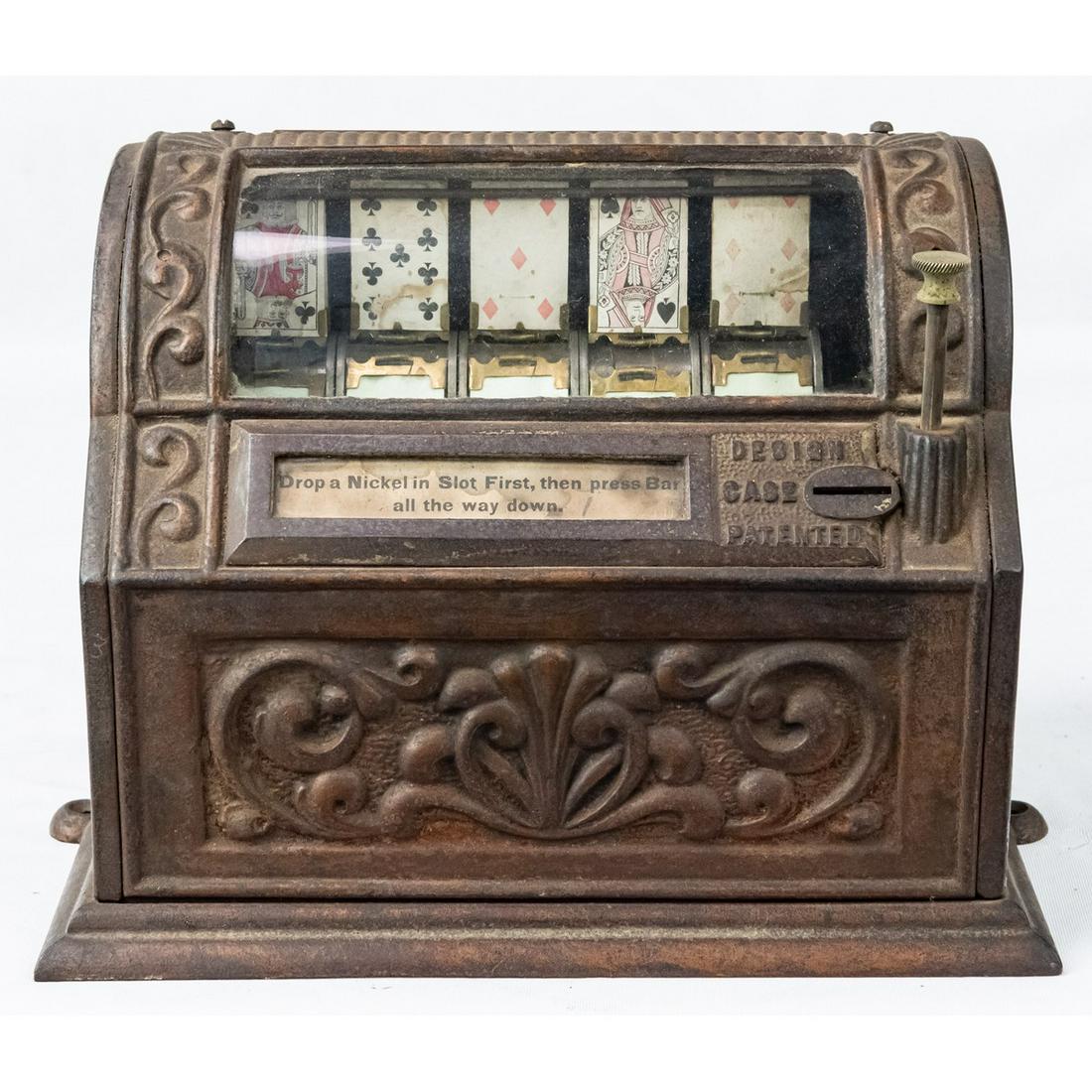 Vintage Cast Iron Flip Card Poker Machine: A cast iron flip card machine flipping 5 cards to create a poker hand. Machine is operated by pushing bar on right side all the way down and releasing it. Machine has glass panel for viewing hand and 