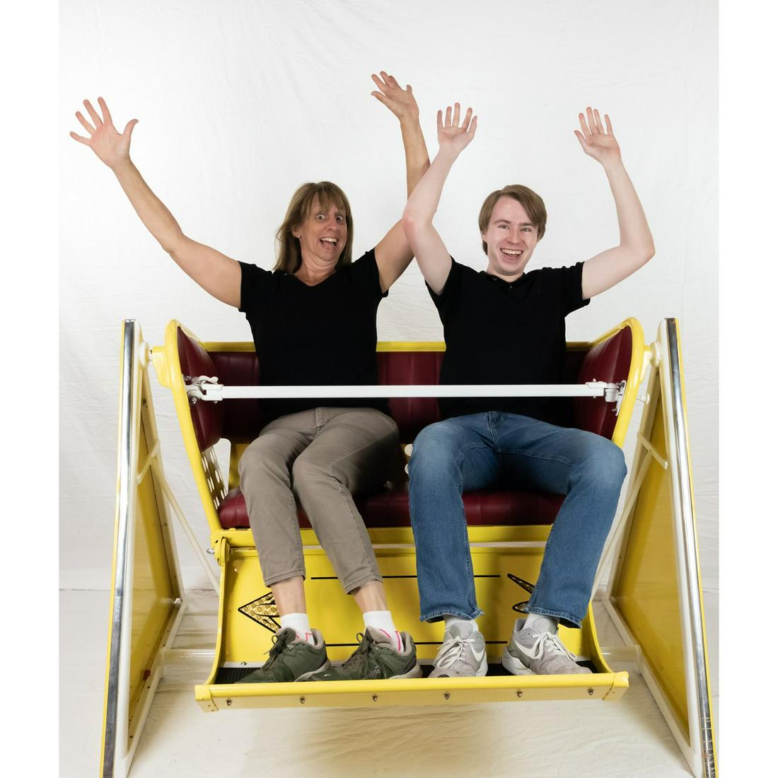 Ferris Wheel Ride Seat: A seat for a Ferris wheel consisting of a base with triangular sides and the seat itself. Steel base has sides marked "5¢ a Ride". Seat is marked "#4" on the sides and has a folding footrest. Sides o