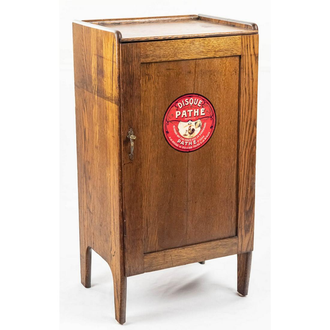 Oak Piano Roll/Music Cabinet W/Pathe Logo: This oak cabinet has original finish with usual wear present and is in as found condition. Has original cabinet latch and 5 shelves. Has a 7"D Pathe logo on the front door. A great restoration project