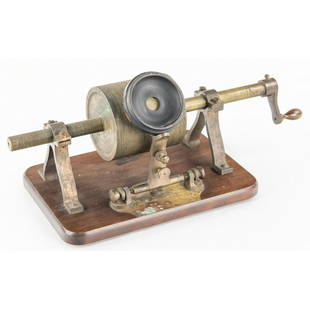 Tin Foil Phonograph: Made by D&H Precision Tool Co. Newark New Jersey. Mahogany base measures 11 1/4” x 7 1/4”. Wood reproducer with diaphragm but no stylus. Other parts made of brass and feed screw moves freely.