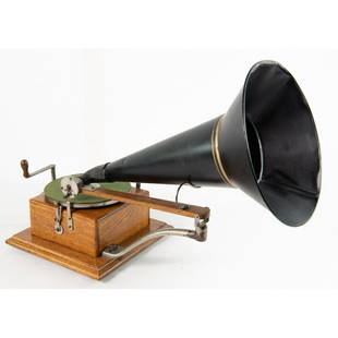 American Berliner Trademark Disc Phonograph: Original finish oak cabinet with original decal that reads “’Berliner Gramophone’” and patent dates from 1887-1895. All exterior parts appear to be original with overall +85% plating. Motor sp