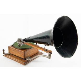 Berliner Ratchet Wind Disc Gramophone: Circa 1896 Original finish oak case. All original nickel parts have very good original plating. Seldom seen original strap reproducer with no serial number but stamped E. Berliner’s Patents with