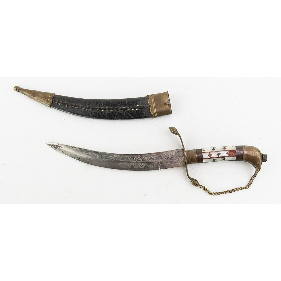South American Curved Dagger: South American curved dagger with etched blade from 1920's to 30's Leather scabbard with brass fittings and grip. Blade measures 7.5" long. In VG condition.