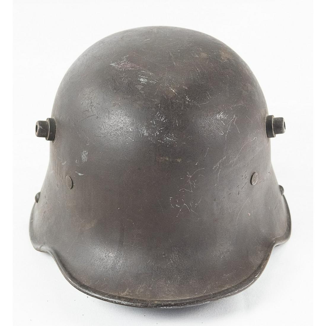 WWI Imperial German M16 Helmet: A WWI Imperial German Model 1916 helmet, the original stahlhelm. Helmet features a 3 leather pad liner and older style chin strap loops. Inside of helmet rim is marked "S1.62". Helmet exterior is in o