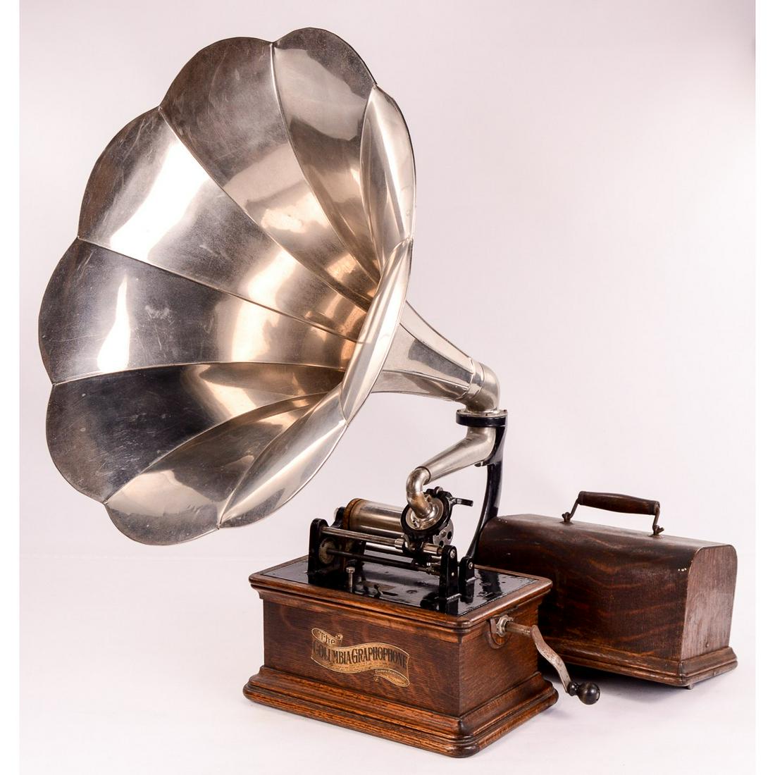 Columbia BKT Cylinder Phonograph: This machine has its original golden oak finish and decals. Overall good untouched original condition. However, the cover is dirty with some finish loss and several minor shrinkage cracks and evidence