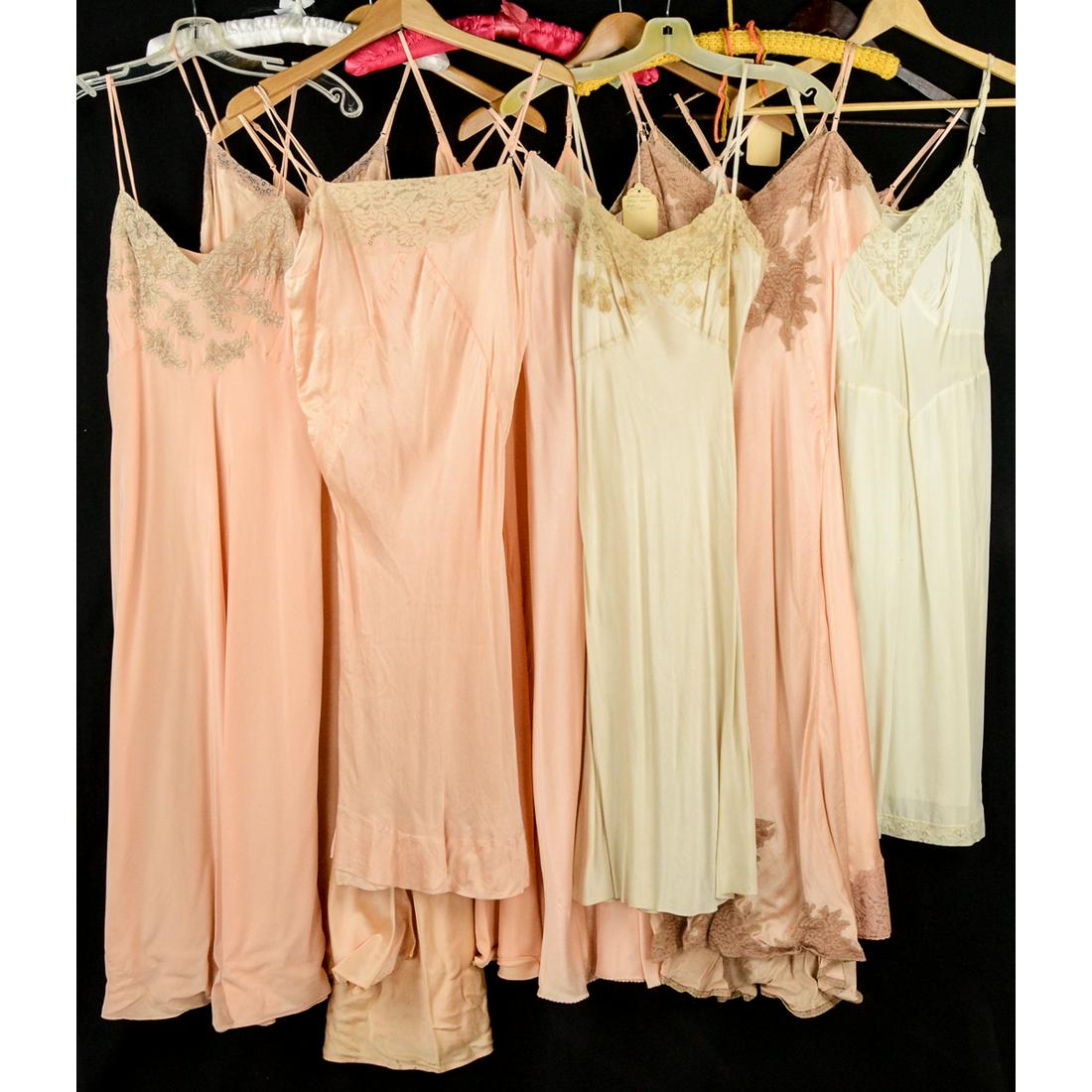 10 Piece Lot 1930's-40's Lingerie: Mostly 1930s silk and satin bias cut slips with French lace. Colors include peach, nude and pink. One slip has been repaired. Sizes range from small to large. The ultimate highlight of this grouping i