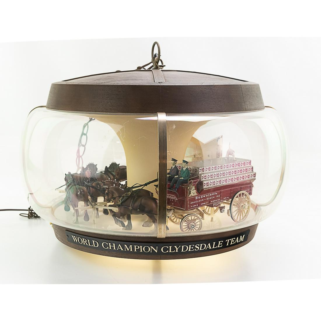 1960's Budweiser Clydesdale CarouselLight: A real classic, This Budweiser carousel light features a model of the famous Clydesdale team pulling a beer wagon, followed by dalmations. The light and the motion work. It measures 23"W x 13"H. There