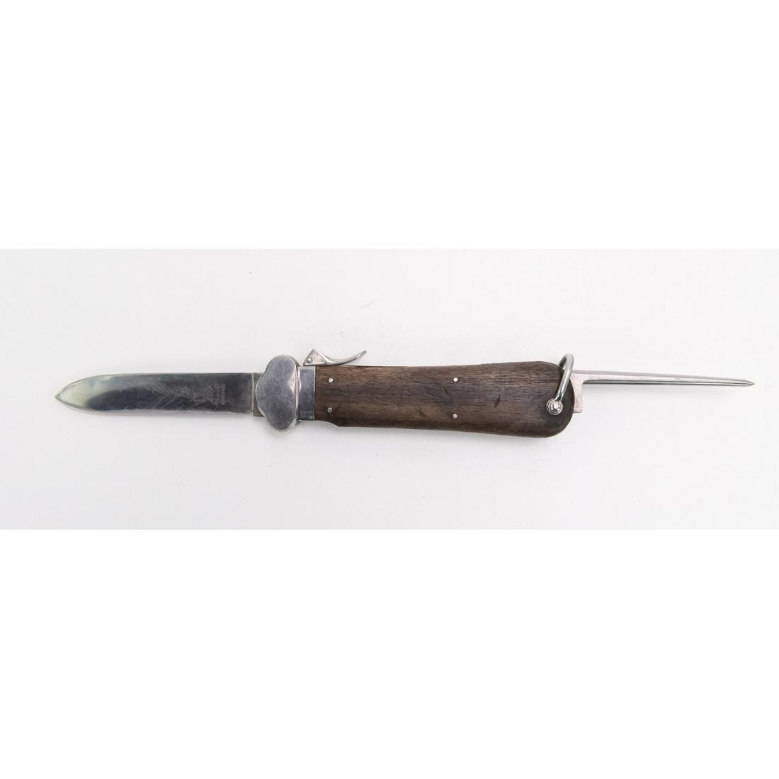 WWII German Paratroopers Gravity Knife: WWII German Paratroopers Gravity Knife with a great blade. It is manufacturer marked "SMF , Solingen, Rostfrei". with seated king logo, the knife is functional, however, the lower frame is missing a p