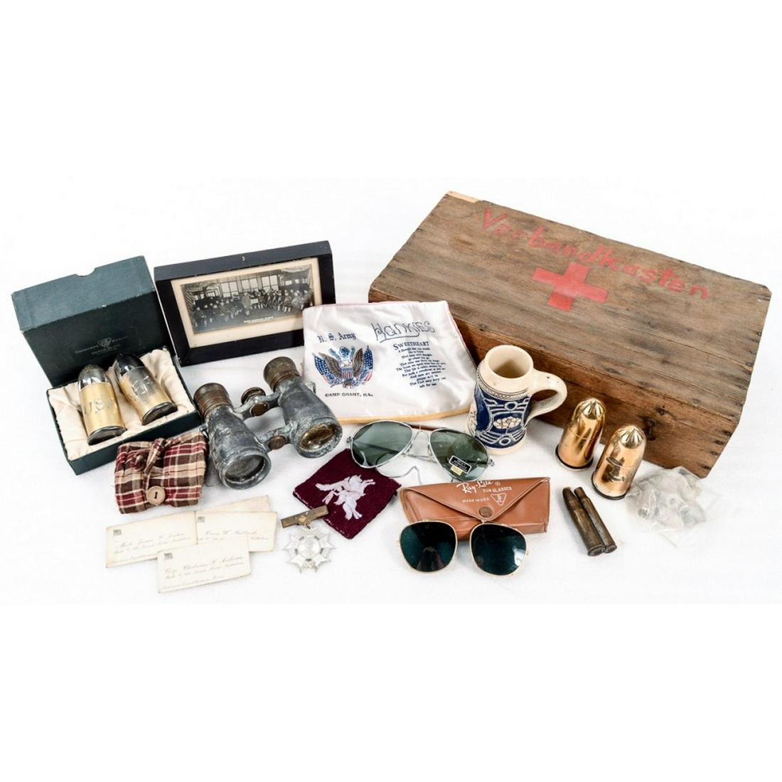 German First Aid Box w Trench Art Stein Binoculars: Includes a pair of WWII Spindler and Hoyer field glasses. First Wisconsin Cavalry Monument Stein, Ray-Lite sunglasses, a pair of A.E.F. engraved salt and pepper shakers in original box, and more.