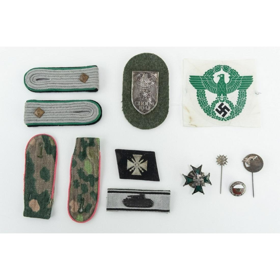WWII German Epaulets, Badges, Patches, Stick Pins: In Riker Mount and includes: German Police Eagle, 2 pairs shoulder boards - SS1st Lt of Panzer Grenadier and SS DOT pattern camo epaulets, Panzer. Cholm 1942 campaign shield, early HJ pin, Spanish cro