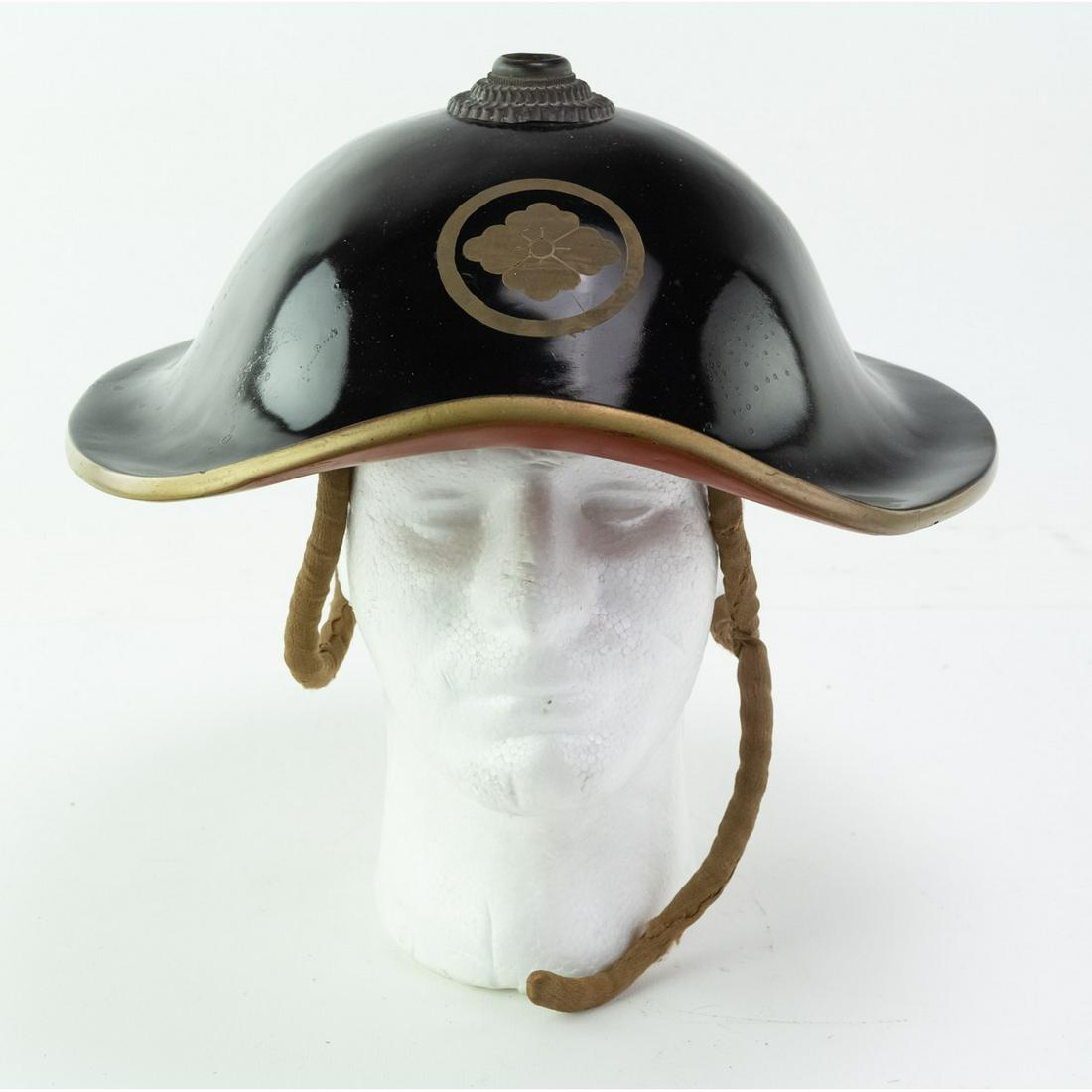 Pre WWII Japanese Jinkasa, Jingasa Helmet: Lacquer Ware helmet with family crest on the front. It has all of its fittings and liner with chinstrap. Measures 12 1/2"W X 13 1/2D X 4"H.