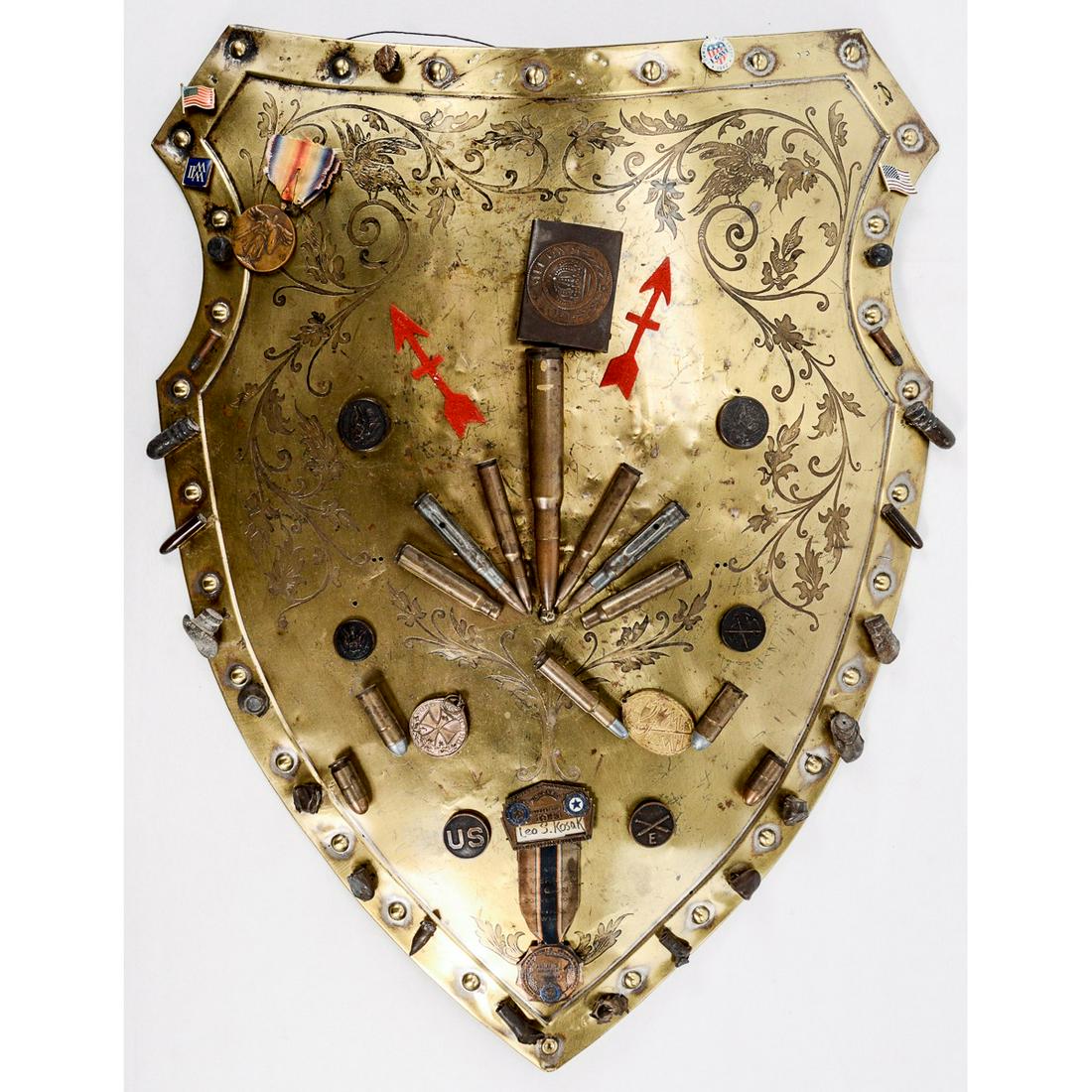 WWI US 32nd Division Battlefield Pickup Shield: A large brass shield with battlefield pickup articles attached. Named to "Leo S. Kosak". Kosak served as a Captain of Company K of the 1st Wisconsin Infantry Regiment attached to the 32nd "Red Arrow"