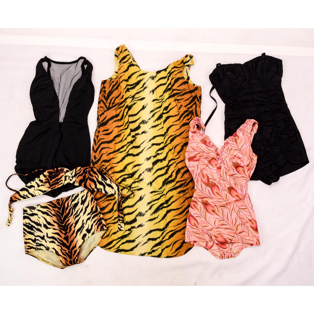 Four Vintage 1940-50's Women's Bathing Suits: 1. Peacock feather pattern one-piece swimsuit. Size small. Excellent condition. 2. Black with netting inset. "Cole of California." Size small. Excellent condition. 3. Black gathered swimsuit. Back met