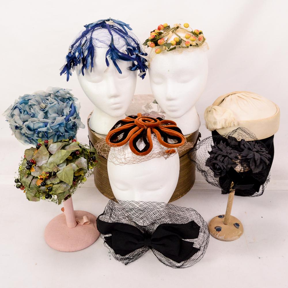 Lot of 13 Ladies Hats from 1958-1963: Fascinators, whimseys, net hats, and pill boxes are included in this lot. The face nets are all in excellent condition. Some are adorned with flowers, ribbons, velvet trim, bows, sequin, and tiny mini