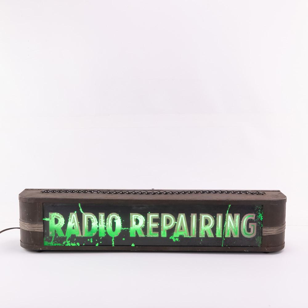 1930s Lighted Radio Repair Sign: Very scarce sign. In working condition. Some wear on lettering and glass may have a break or crack, but still the sign looks great. Manufactured by the Ohio Advertising Display Company. 5.5"x27"x4.25.
