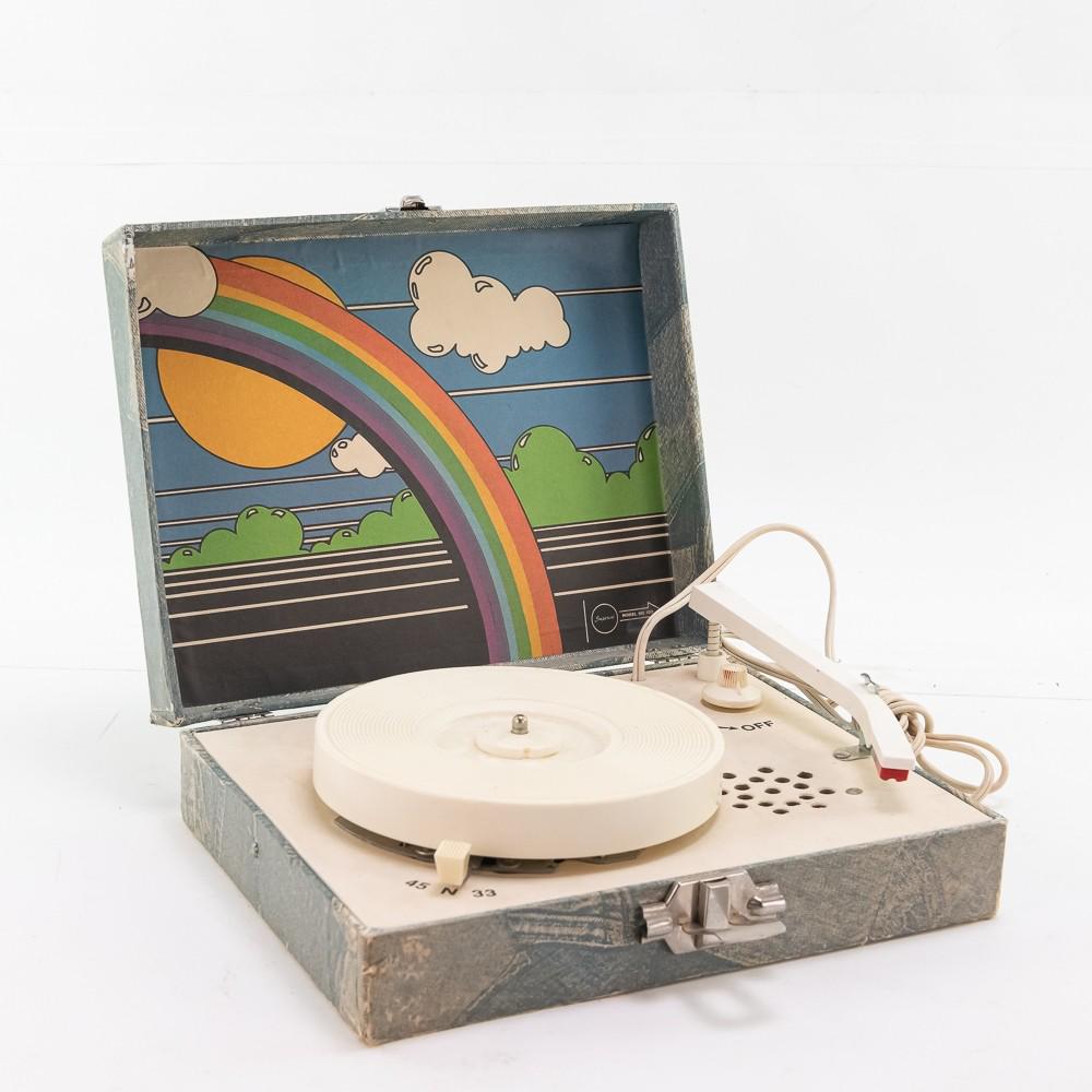 Imperial Portable Electric Record Player: This interesting small portable electric record player, most likely from the 1970's, featuring faux blue jean graphics on the outside of the case as well as a multicolored psychedelic inspired graphic