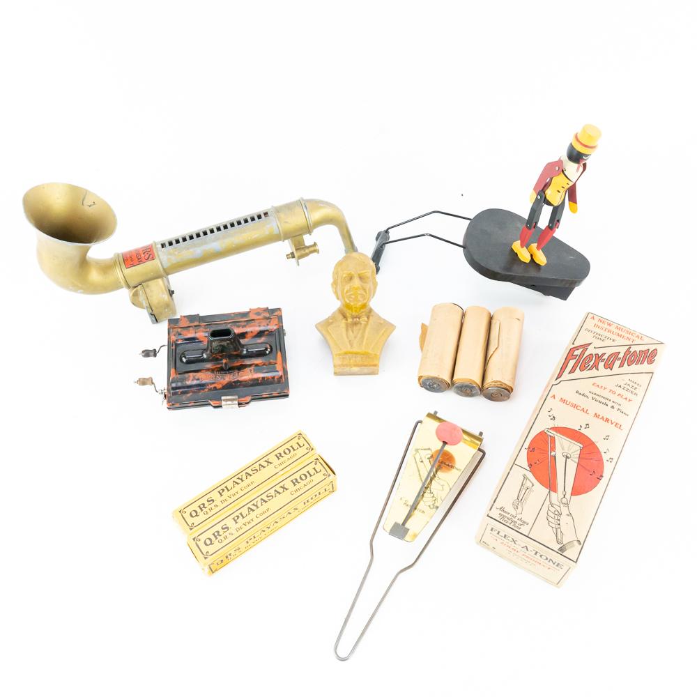(10) Phonograph Toy Rastus, PlayASax, Flexatone: 10 items including the rolls. Mixed lot with several items. Ragtime Rastus Phonograph Toy made by Charlie Weatherbee replica. QRS PLAYASAX with two rolls. Edison small composite mold statue. Flex-A To